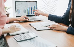 Business concept. Business people discussing the charts and graphs showing the results of their successful teamwork.